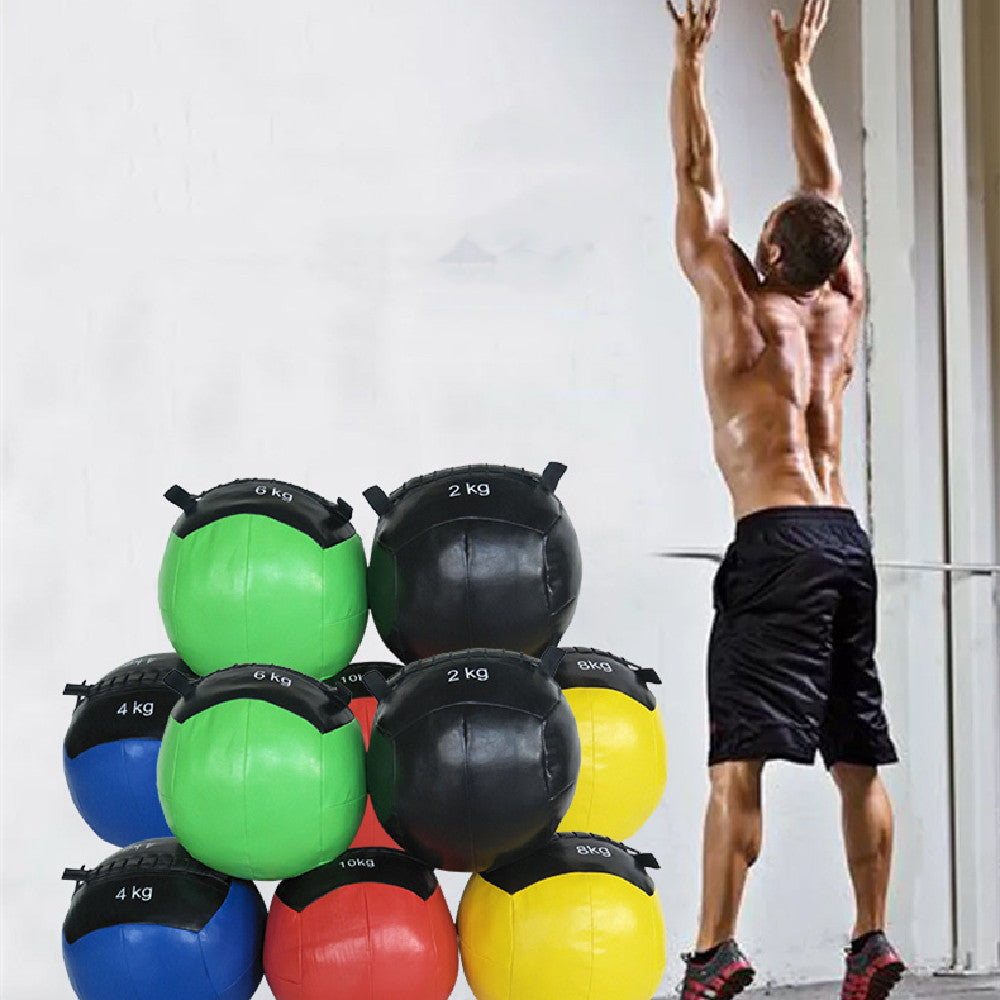 Man exercising with colorful fitness balance gravity balls stacked nearby