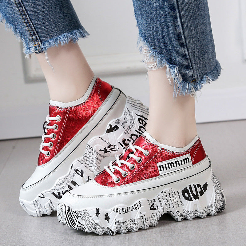 Red casual platform sneakers with white graffiti rubber sole and round toe design